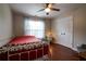 Bedroom with a ceiling fan, curtains, window, closet, and a red bedspread at 120 Clifford Ct, Canton, GA 30115
