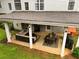 Aerial view of a covered patio with seating, dining, grill and playhouse set in a private backyard at 120 Clifford Ct, Canton, GA 30115
