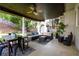 Spacious covered patio with a dining area, comfortable seating, and a cozy outdoor ambiance at 120 Clifford Ct, Canton, GA 30115