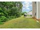 A spacious backyard featuring a lush lawn and a patio with outdoor furniture at 4015 Soaring Dr, Douglasville, GA 30135