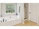 Inviting bathroom with soaking tub and separate shower with a large window at 4015 Soaring Dr, Douglasville, GA 30135