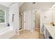 Bathroom with soaking tub and separate shower, next to double vanity at 4015 Soaring Dr, Douglasville, GA 30135
