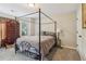 Bedroom with a canopy bed, neutral walls, and a window providing natural light at 4015 Soaring Dr, Douglasville, GA 30135