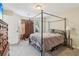 Comfortable bedroom showcasing a canopy bed and natural light from the window at 4015 Soaring Dr, Douglasville, GA 30135