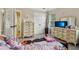 Light-filled bedroom with plush carpet and a TV at 4015 Soaring Dr, Douglasville, GA 30135