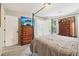 Cozy bedroom featuring a canopy bed and wooden dresser with a television on top at 4015 Soaring Dr, Douglasville, GA 30135