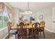 Cozy dining room with wooden table, decorated chairs, and natural light from the window at 4015 Soaring Dr, Douglasville, GA 30135