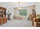 Bright dining area with a classic chandelier, large window, and easy access to the kitchen at 4015 Soaring Dr, Douglasville, GA 30135