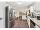 Updated kitchen with stainless appliances, granite counters, white cabinets, and wood-look flooring at 4015 Soaring Dr, Douglasville, GA 30135