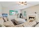Cozy living room featuring a large sectional sofa, fireplace, and modern entertainment center at 4015 Soaring Dr, Douglasville, GA 30135
