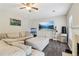 Comfortable living room featuring a large sectional sofa, a ceiling fan and a modern entertainment setup at 4015 Soaring Dr, Douglasville, GA 30135