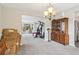 Open floor plan with neutral walls, carpet, and chandelier lighting at 4015 Soaring Dr, Douglasville, GA 30135