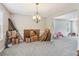 Open floor plan with neutral walls, carpet, and chandelier lighting at 4015 Soaring Dr, Douglasville, GA 30135