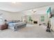 Spacious main bedroom boasting carpet floors, a vaulted ceiling, and a cozy fireplace at 4015 Soaring Dr, Douglasville, GA 30135