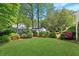 Large, well-manicured backyard with lush green grass, privacy fence, and beautiful landscaping at 3005 Howell Mill Rd, Atlanta, GA 30327