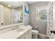 Bright bathroom featuring a marble vanity, patterned floor tiles, and a window offering natural light at 3005 Howell Mill Rd, Atlanta, GA 30327