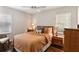 Cozy bedroom featuring warm-toned bedding, hardwood floors, and natural light from the surrounding windows at 3005 Howell Mill Rd, Atlanta, GA 30327