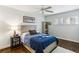 A cozy bedroom with hardwood floors and a ceiling fan at 3005 Howell Mill Rd, Atlanta, GA 30327