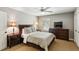 This bedroom features a large bed, dark wood furniture, and a ceiling fan at 3005 Howell Mill Rd, Atlanta, GA 30327