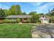 Charming home featuring manicured lawn, mature trees, and a circular driveway, creating curb appeal at 3005 Howell Mill Rd, Atlanta, GA 30327