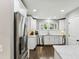 Bright kitchen with stainless steel appliances, white cabinets, and stone countertops for a modern touch at 3005 Howell Mill Rd, Atlanta, GA 30327