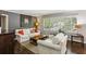Bright living room with hardwood floors, large windows with plantation shutters, and comfortable furnishings at 3005 Howell Mill Rd, Atlanta, GA 30327