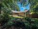 View of the back exterior with screen porch and garden with a small pond at 3075 Nuthatch Nw Ct, Kennesaw, GA 30144