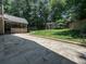 Beautiful backyard features a stone patio, pergola swing set, and a well-manicured lawn at 3075 Nuthatch Nw Ct, Kennesaw, GA 30144