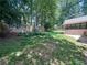 Beautiful backyard with a swing set, privacy fence, and mature trees at 3075 Nuthatch Nw Ct, Kennesaw, GA 30144
