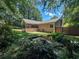 Private backyard featuring lush landscaping, mature trees and a decorative fish pond at 3075 Nuthatch Nw Ct, Kennesaw, GA 30144
