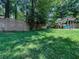 Well maintained lawn with a swing set visible behind a modern fence at 3075 Nuthatch Nw Ct, Kennesaw, GA 30144