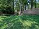 A green backyard with a modern horizontal fence and waterfall feature at 3075 Nuthatch Nw Ct, Kennesaw, GA 30144