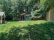 Lush backyard with a wooden swing set and a well-maintained lawn, perfect for outdoor activities at 3075 Nuthatch Nw Ct, Kennesaw, GA 30144