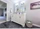 Bathroom featuring a double vanity, gray walls and dark gray tiled floor at 3075 Nuthatch Nw Ct, Kennesaw, GA 30144