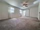 Bright bedroom with ample natural light, ceiling fan, and neutral carpeting at 3075 Nuthatch Nw Ct, Kennesaw, GA 30144