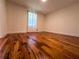 A bedroom featuring hardwood floors and a window with sheer curtains at 3075 Nuthatch Nw Ct, Kennesaw, GA 30144