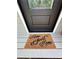 Coir doormat with a 'Home Sweet Home' message welcomes visitors at the front door at 3075 Nuthatch Nw Ct, Kennesaw, GA 30144