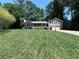 Charming home with two-car garage, covered porch, manicured lawn, and lush landscaping at 3075 Nuthatch Nw Ct, Kennesaw, GA 30144