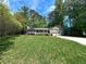 Charming home with two-car garage, covered porch, manicured lawn, and lush landscaping at 3075 Nuthatch Nw Ct, Kennesaw, GA 30144