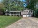 Attractive home featuring a two-car garage, front porch, and a well-maintained yard at 3075 Nuthatch Nw Ct, Kennesaw, GA 30144