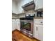 A stainless steel gas range with stainless steel vent hood and white cabinets at 3075 Nuthatch Nw Ct, Kennesaw, GA 30144