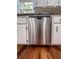 A stainless steel dishwasher with white cabinets and hardwood floors at 3075 Nuthatch Nw Ct, Kennesaw, GA 30144