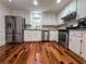 Charming kitchen featuring stainless steel appliances, granite counters, and hardwood flooring at 3075 Nuthatch Nw Ct, Kennesaw, GA 30144