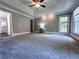 Large main bedroom featuring a tray ceiling, carpeted flooring, and access to an en-suite bath at 3075 Nuthatch Nw Ct, Kennesaw, GA 30144