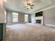 Spacious main bedroom featuring a fireplace, tray ceiling, and a comfortable carpet at 3075 Nuthatch Nw Ct, Kennesaw, GA 30144
