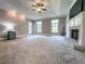 Spacious main bedroom featuring a fireplace, tray ceiling, and two large windows at 3075 Nuthatch Nw Ct, Kennesaw, GA 30144