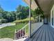 Inviting porch with white railings, hanging plants, and views of the landscaped front yard at 3075 Nuthatch Nw Ct, Kennesaw, GA 30144