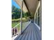 Inviting porch with white railings, hanging plants, and views of the landscaped front yard at 3075 Nuthatch Nw Ct, Kennesaw, GA 30144