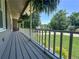 Relaxing covered porch with white railing, hanging plants, and pleasant neighborhood views at 3075 Nuthatch Nw Ct, Kennesaw, GA 30144