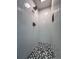 Modern shower featuring white tile and a stylish mosaic tile floor at 3075 Nuthatch Nw Ct, Kennesaw, GA 30144